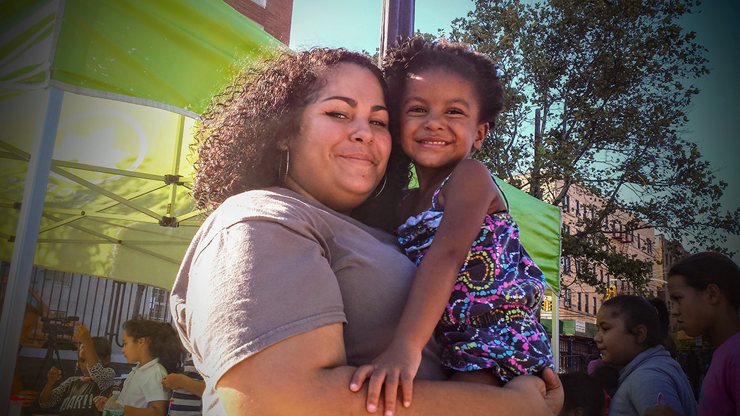 A woman and a kid pose for a photo