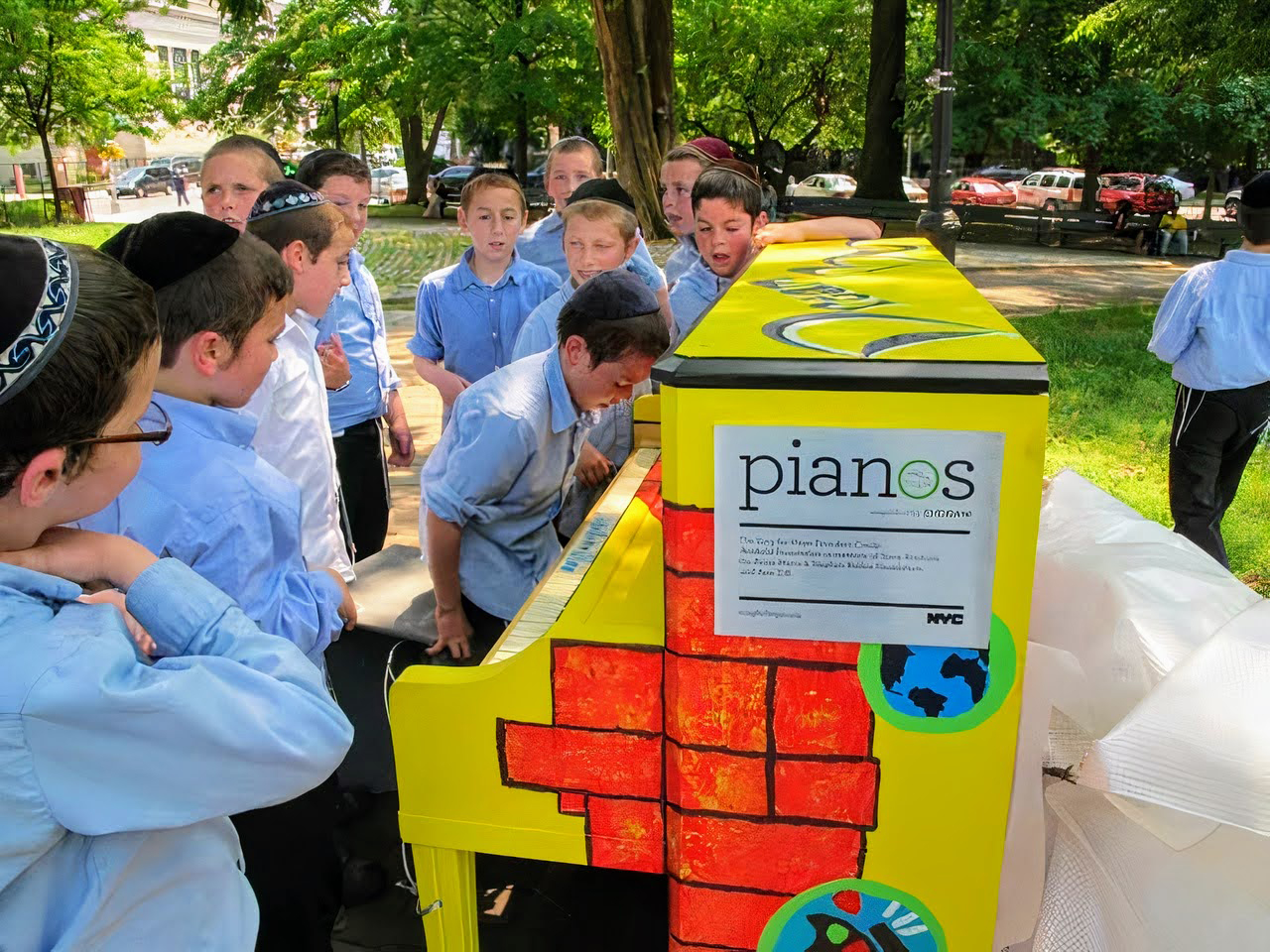 Kids play on a piano in the park