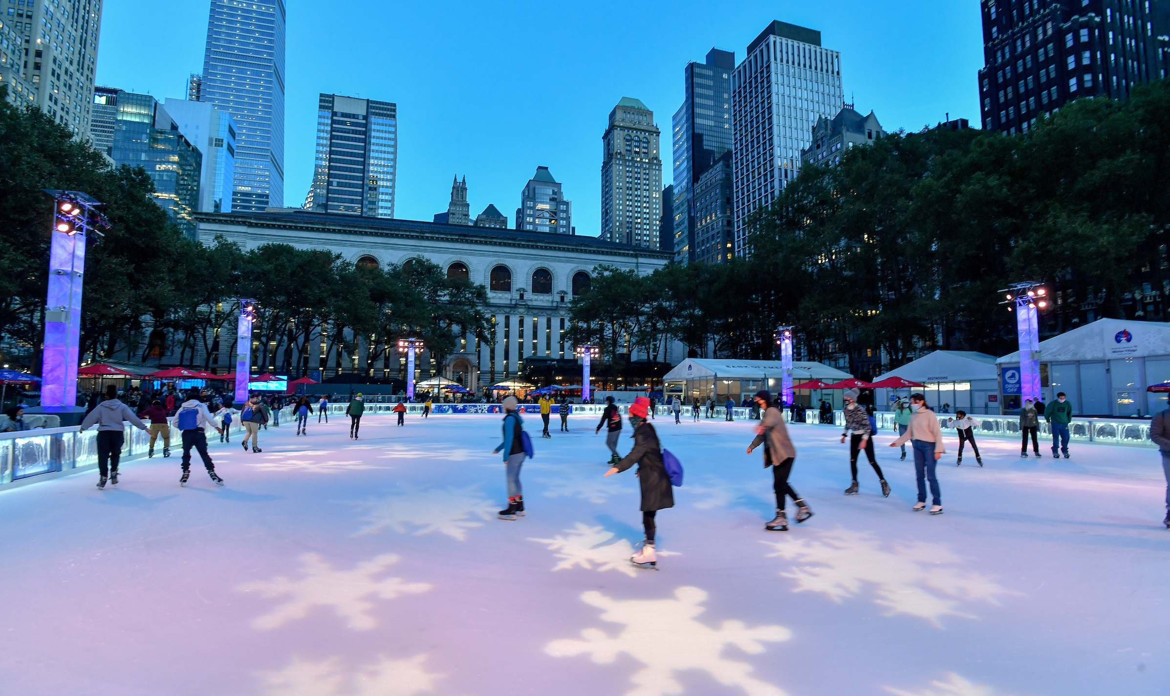 skaters enjoy skating on the ice at twilight