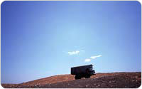 Payahuler climbs a mountain on its way to dump garbage at Fresh Kills, 1999, photo by Michael Falco