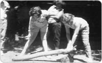 Girl Scouts cutting wood