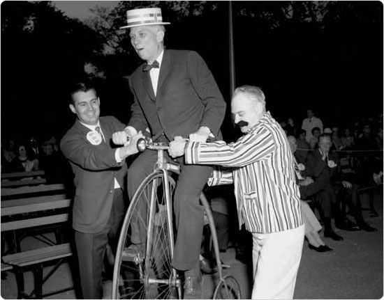 Parks Commissioner August Heckscher attempts to ride a penny-farthing at the Central Park Bicycle Bash, May 23, 1967. Courtesy of Parks Photo Archive; Neg. 40054-3.