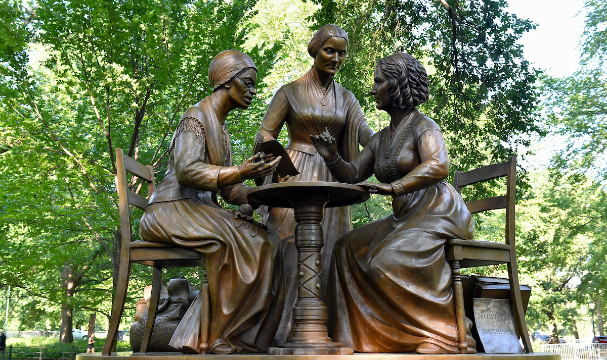 The statue depicts Sojourner Truth, Elizabeth Cady Stanton, and Susan B. Anthony having a discussion at a table