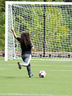  a child plays soccer on the field