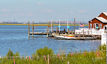 a house sits on a dock surrounded by salt marshes