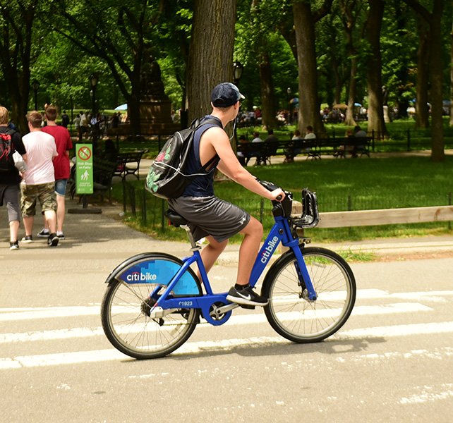 A person riding a bicycle that reads 'Citi Bike.'