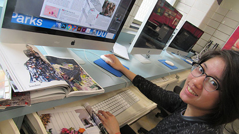 a teen uses software to design magazine pages