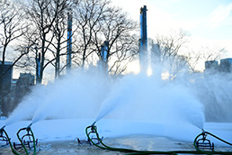 Snow is being blown in the park in preparation for Winter Jam