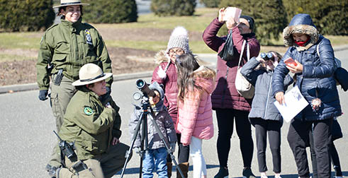 Urban Park Rangers teach kids and their families how to use telescopes and binoculars to go birding