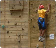 Climbing a wall at the adventure course