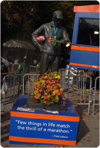 A statue of former NYRR President Fred Lebow awaits runners at the finish line to the New York City Marathon.