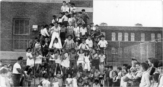 Masses of children climb the jungle gym adjacent to PS 21 in the Bronx, September 27, 1943. Courtesy of Parks Photo Archive; Neg. 22675.