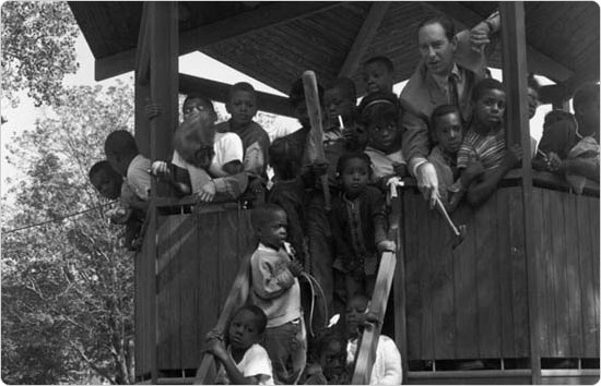 Parks Commissioner Thomas Hoving poses with children at the pavilion in Tompkins Park, Brooklyn on August 8, 1966. Courtesy of Parks Photo Archive; Neg. 32622.