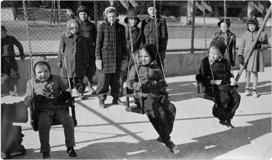 Children enjoy the swings at Paerdegart Park in Brooklyn, January 9, 1943. Courtesy of Parks Photo Archive; Neg. 21960.