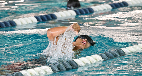 A teenager in the
          middle of a strenuous swim stroke.