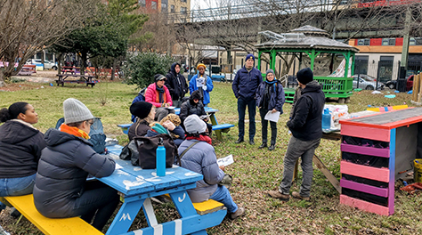 people attend a workshop in a garden