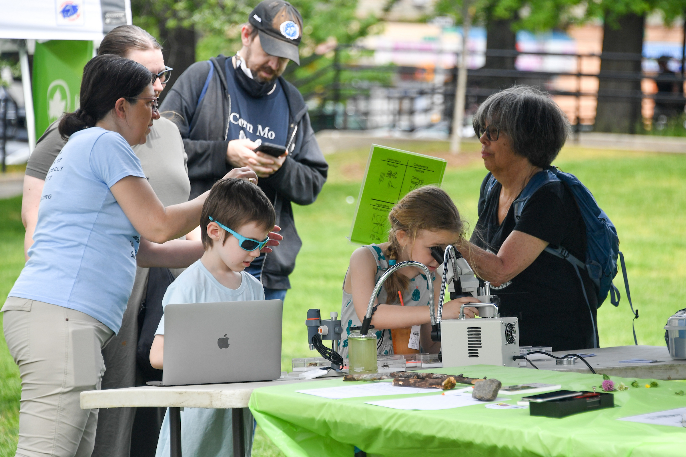 A child looks interacts with a laptop on a display table.