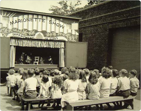 1941, a captive audience enjoys a marionette performance in Forest Park, Queens.