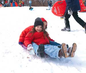 Children enjoy the snow at the Winter Festival in Central Park