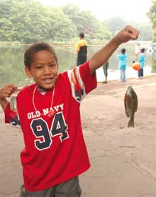 Child holding up a fish caught in Prospect Park