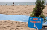 Sign next to beach mat saying Beach Access Path