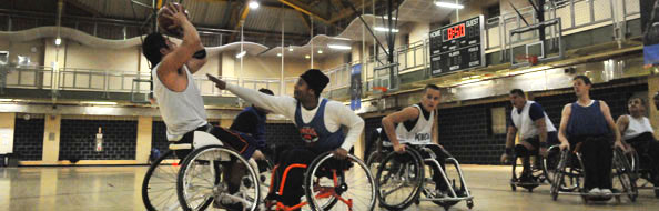 People playing wheelchair basketball at a recreation center