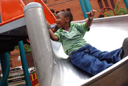 kid sliding down a spiral slide