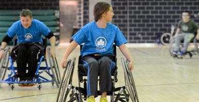 People in wheelchairs in a gym