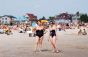 Two woman posing near the water.