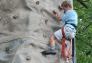 Enjoying the challenge of a rock climbing wall