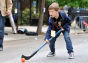 A boy playing street hockey.