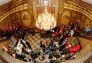 The choir sings carols for a gathered crowd in the building's lobby