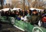 The crowd watches the snowboarders perform