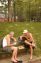 Father and son playing friendly game of chess on warm August day in Astoria Park.