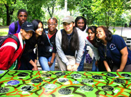 Students from PS 219 gather behind their work at Claremont Park, Bronx. Photo courtesy of LEAP.